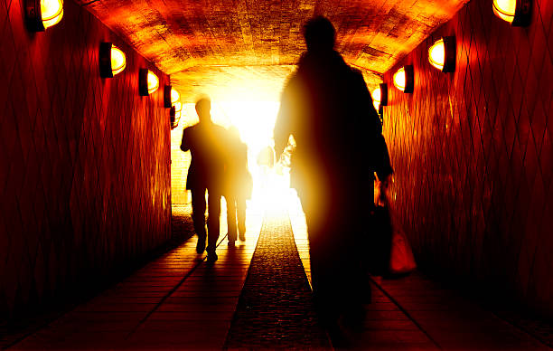 istock Silhouette walking against light at the end of tunnel 531657633