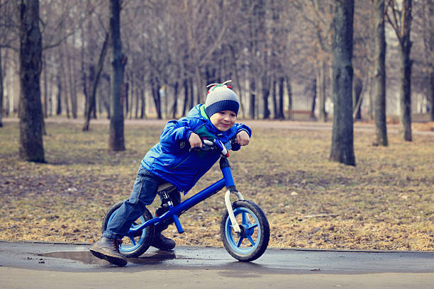 istock happy little boy on running bike in spring 531658225