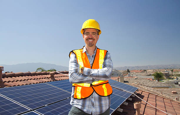 istock Solar Panel Man on Roof Smiles 531658473