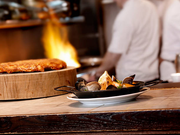 Teppanyaki chef cooking in front of guests.