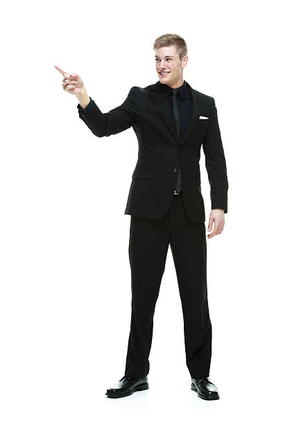 istock Smiling businessman pointing away 531658969