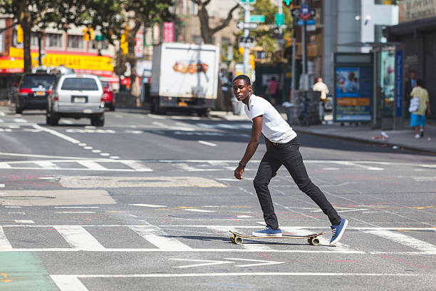 istock Black Boy Skating with Longboard on the Road 531660485