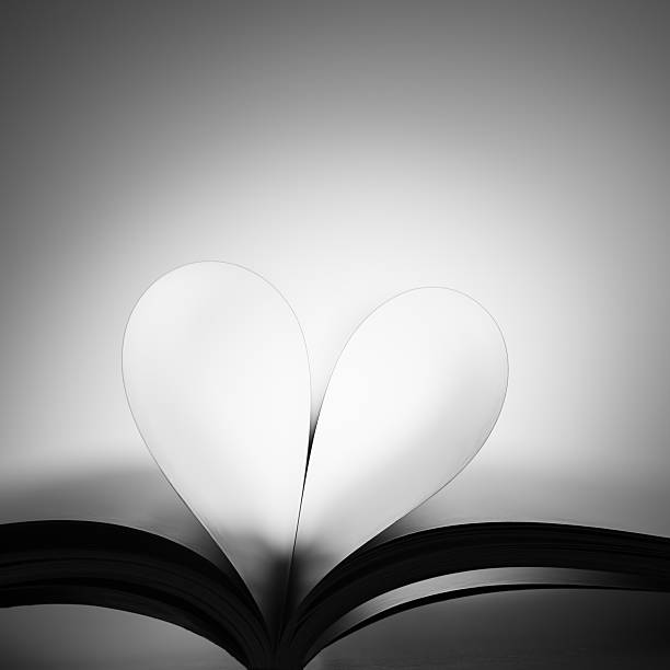 love for books hear from book pages. black and white image abstract newspaper macro heart shape stock pictures, royalty-free photos & images