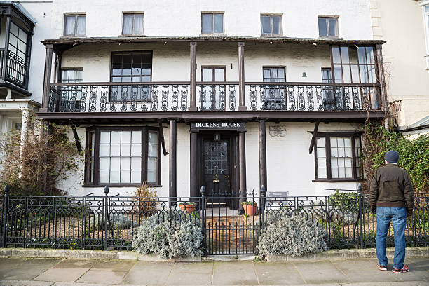 Dickens House Museum, Broadstairs Broadstairs, UK- January 7, 2015: A tourist stands outside the Dickens House Museum. It is housed in the cottage that was Charles Dickens' inspiration for the home of Betsey Trotwood in David Copperfield. isle of thanet photos stock pictures, royalty-free photos & images