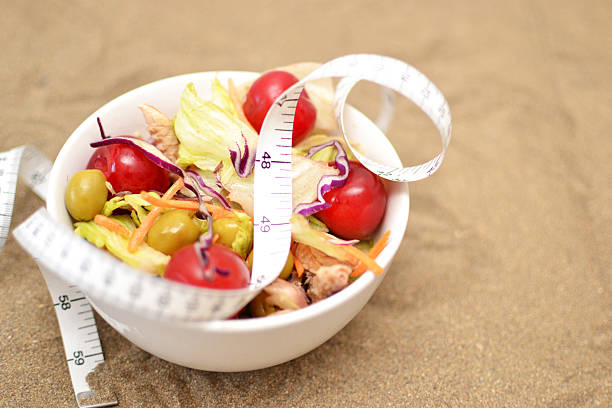 istock salad and tape measure on sand 531671741
