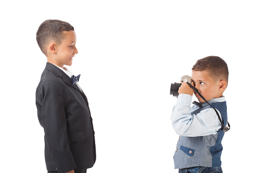 Three little boys photographing via old fashioned cameras