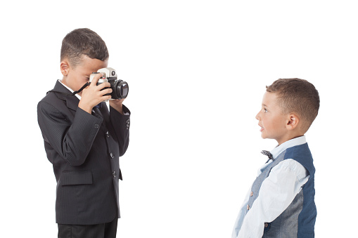 Three little boys photographing via old fashioned cameras