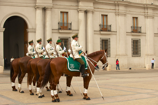 Santiago, Chile - October 18, 2013: Unidentified military of the Carabineros band attend  changing guard ceremony in front of the La Moneda presidential palace on October 18, 2013 in Santiago, Chile.