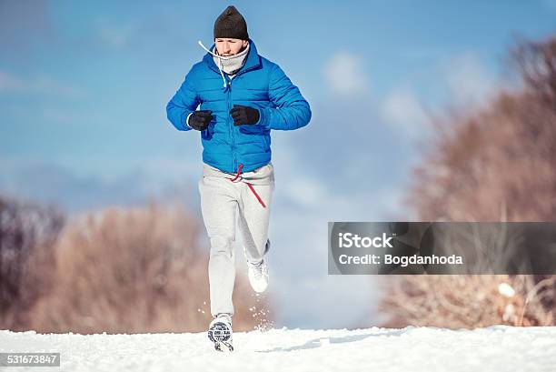 Fitness Concept Of A Man Running Outdoor In Snow Stock Photo - Download Image Now - 2015, Activity, Adult