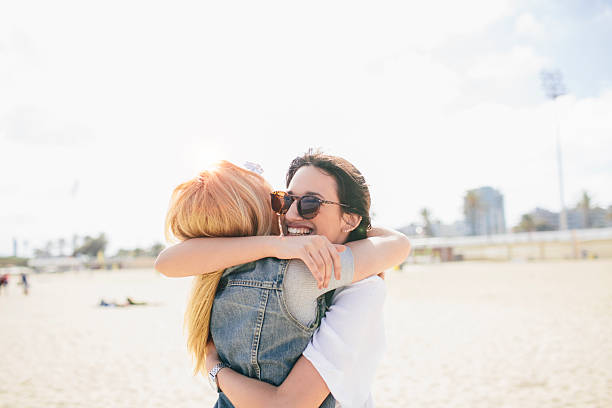 istock Friends enjoying a big hug in the beach. 531686608