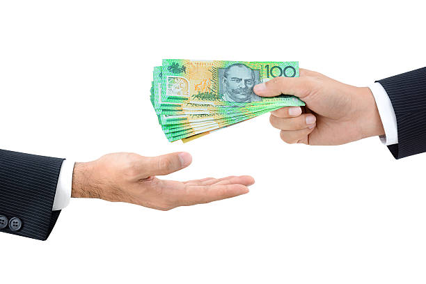 istock Businessman hands passing money, Australian dollar (AUD) banknotes 531686782