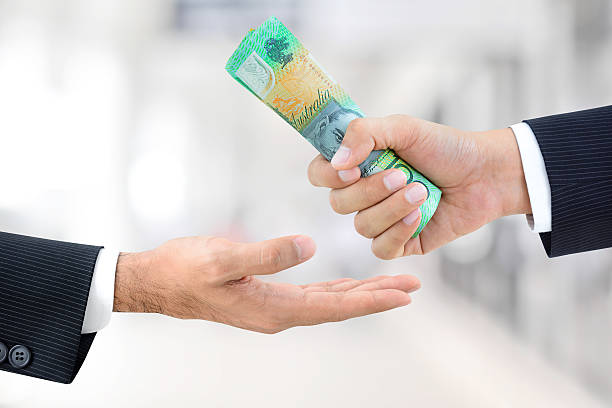 istock Businessman hands passing money, Australian dollar (AUD) banknotes 531686850