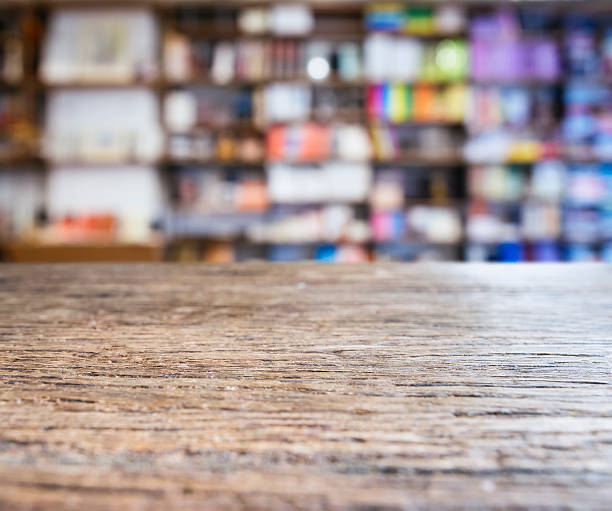 istock Table top with Blurred Bookshelf Bookshop Background 531687292