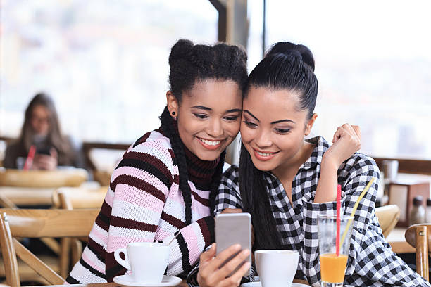 istock Smiling young women using phone in a restaurant 531687620