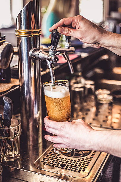 istock beer tap pouring a draught lager beer 531688074