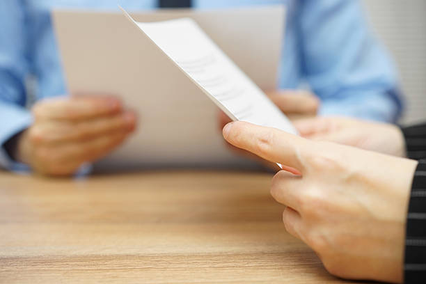 istock business partners reading and negotiating about legal document 531689106