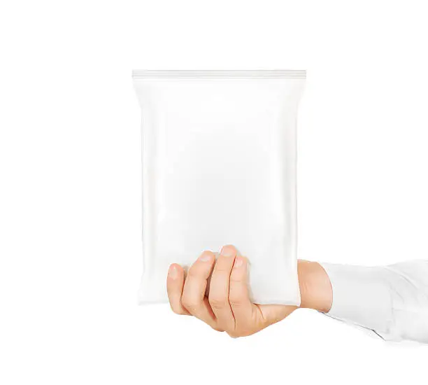 Blank white snack bag mock up hold in hand isolated. Clear white chips pack mockup. Cookie, candy, sugar, cracker, nuts, jujube supermarket foil plastic container ready for logo design presentation.