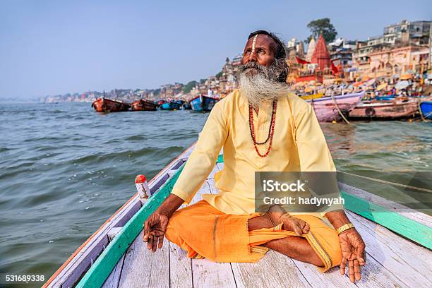 Sadhu Is Meditating In Boat On Holy Ganges River Varanasi Stock Photo - Download Image Now