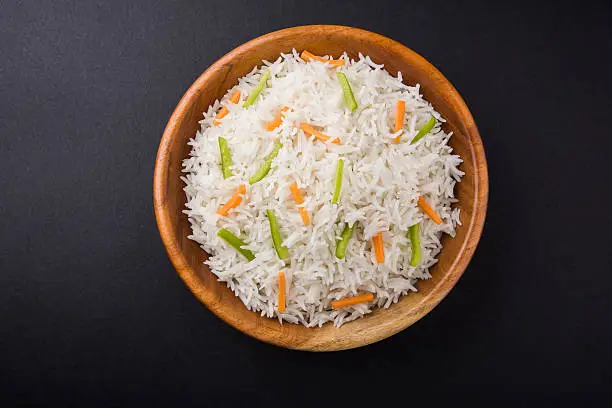 cooked white basmati rice with carrot and capsicum toppings, plain white pulav