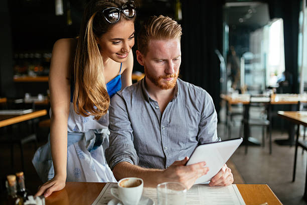 istock Beautiful couple looking at tablet 531689900