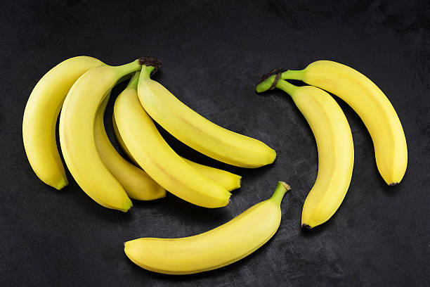 istock Yellow bananas on a dark background 531689944