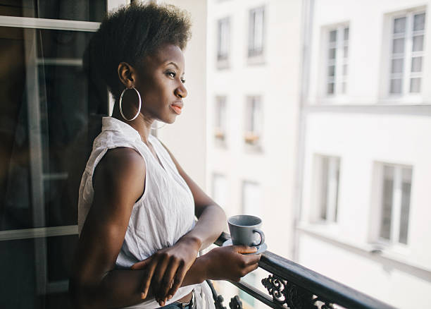 Woman drinking coffee at the balcony