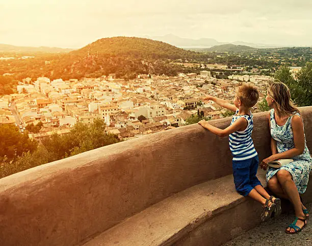 Photo of Mother and son looking at mediterranean view of Mallorca town