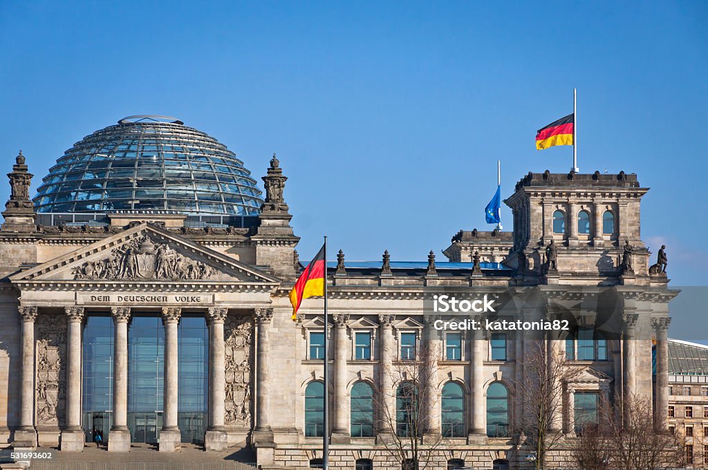 German National flags waving in front of German parliament buildi Flags of Federal Republic of Germany waving in front of the German parliament building (Reichstag) in Berlin, Germany Bundestag Stock Photo