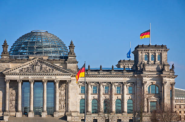 German National flags waving in front of German parliament buildi Flags of Federal Republic of Germany waving in front of the German parliament building (Reichstag) in Berlin, Germany bundestag stock pictures, royalty-free photos & images