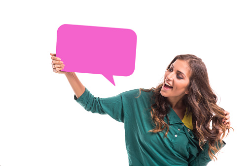 Young girl holding purple speech bubble, isolated on white background.