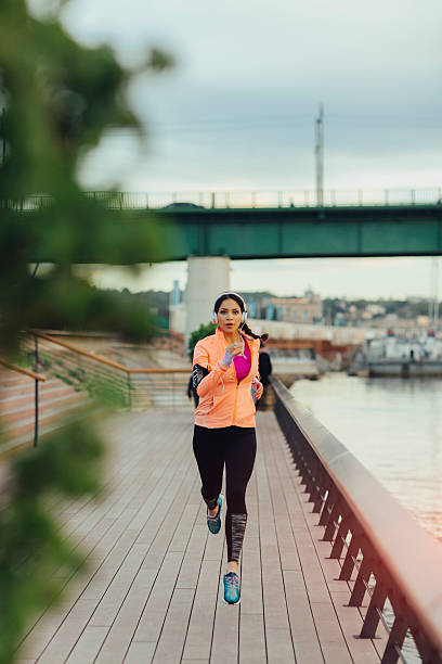 istock Young Woman Jogging Near River. 531693940
