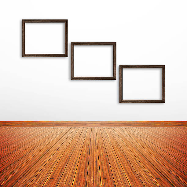 istock Wooden photo frames on white wall inside the room 531694059