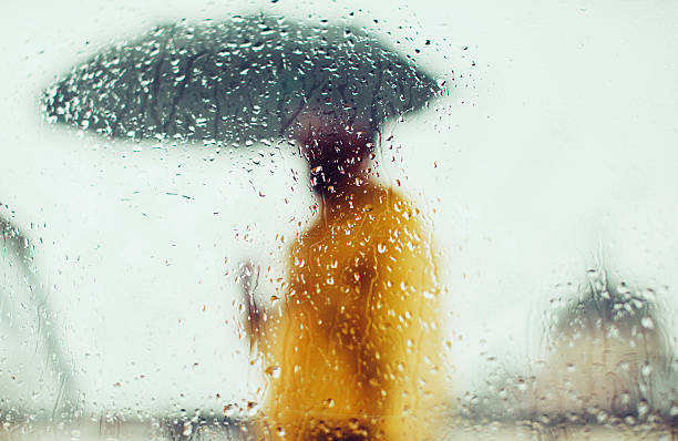 istock Man in yellow jacket with umbrella 531694168