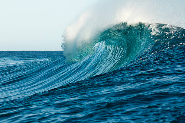 welle in der tube formation in teahupoo beach - reef break stock-fotos und bilder