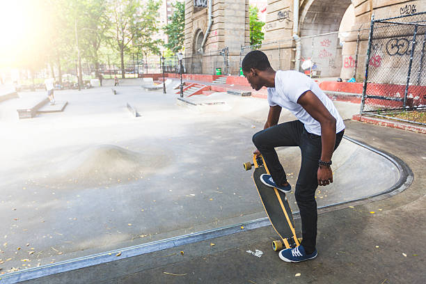 istock Black Boy Skating at Park with Longboard 531695361