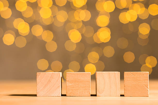 istock Four wooden cubes on flare background 531695651