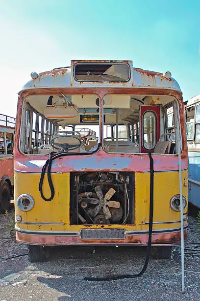 Colorful, rusted, broken down old bus.