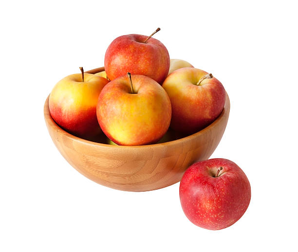 istock Wooden bowl with apples isolated on white 531696042