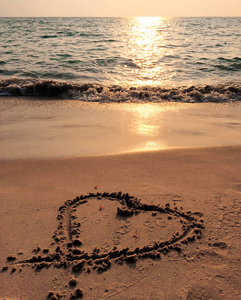istock Sunset sea, heart on the beach and blue wave 531697928