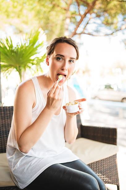 istock woman eating an icecream on summer 531698189