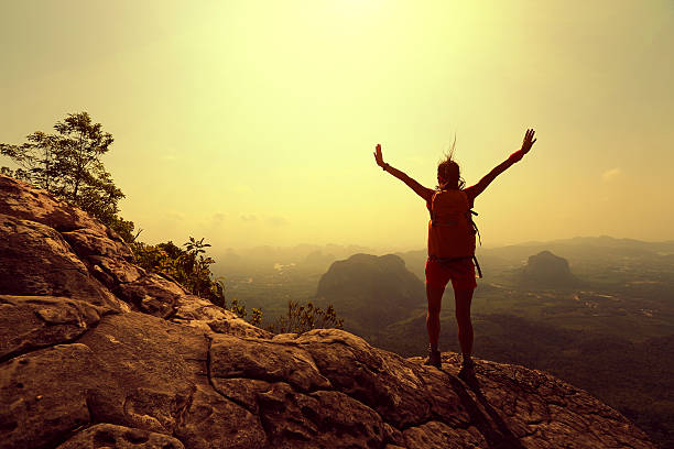 istock young successful woman hiker open arms on mountain peak 531699610