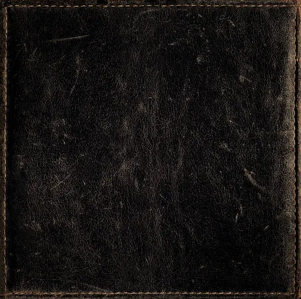 Photo of Black grunge background from distress leather texture with stitched frame