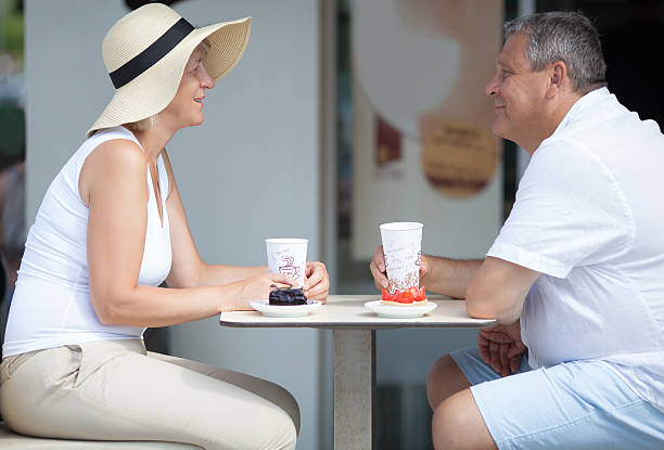 istock Side view of two smiling elderly people in outdoor cafe 531702446