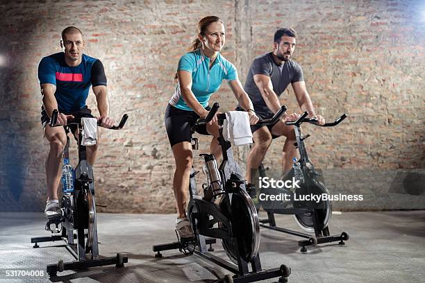 Young People Cycling Workout Stock Photo - Download Image Now - Spinning, Bicycle, Cycling