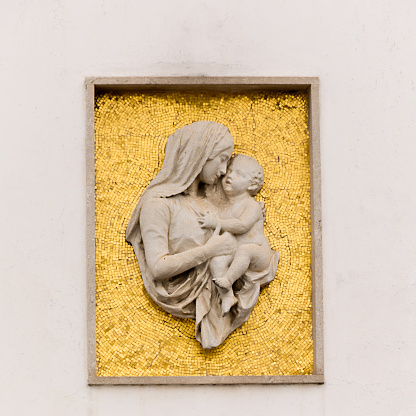 Relief of Virgin Mary  on the facade of the post office in Palmanova, Italy