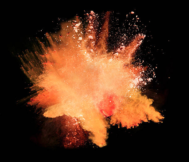 istock Explosion of orange powder on black background 531705586