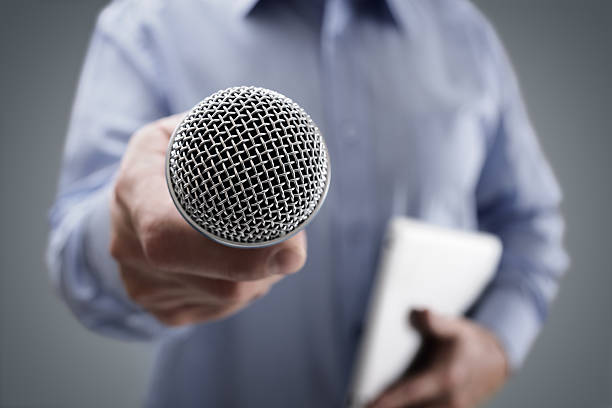 Interview with microphone Hand holding a microphone conducting a business interview or press conference spokesperson stock pictures, royalty-free photos & images