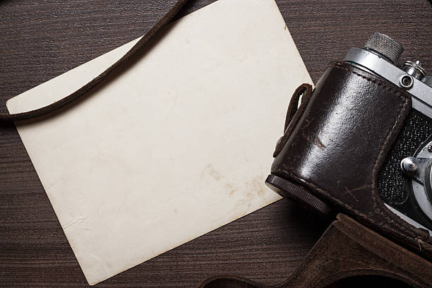 istock retro camera and old photos on brown wooden table 531709119