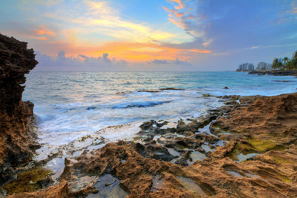 Beautiful sunrise at the rocky coast of San Juan, Puerto Rico, in summer