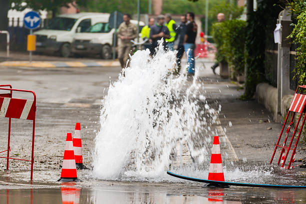 istock road spurt water beside traffic cones 531709707